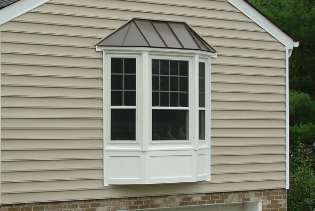 bay window exterior with white panel and standing seam steel roof