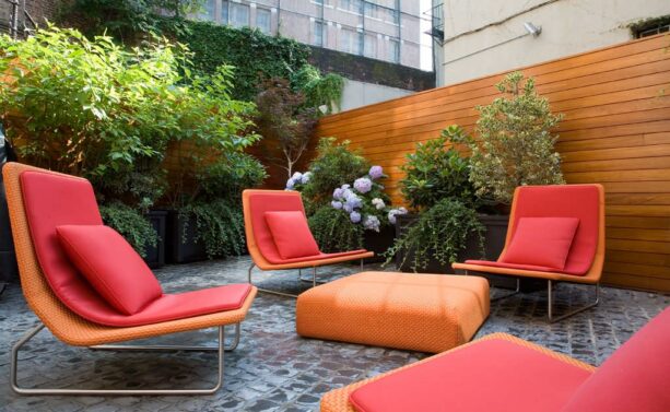bold and vibrant seating in a belgian cobblestone townhouse patio