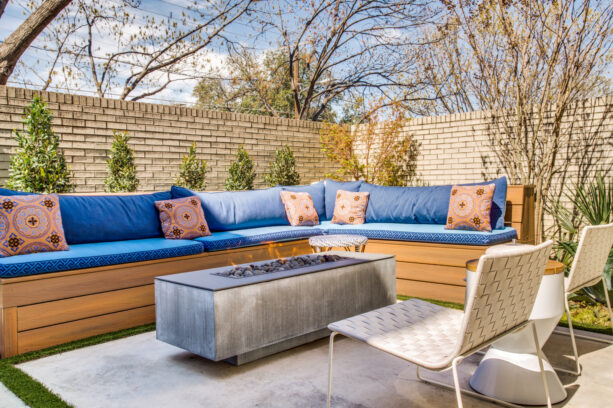 bright l-shaped bench with a fire table in a modern townhouse patio
