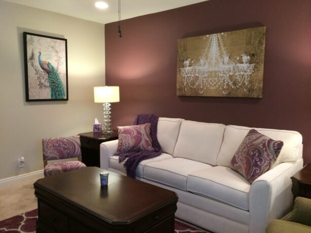 deep purple accent wall with matching rug and fabric in a family room