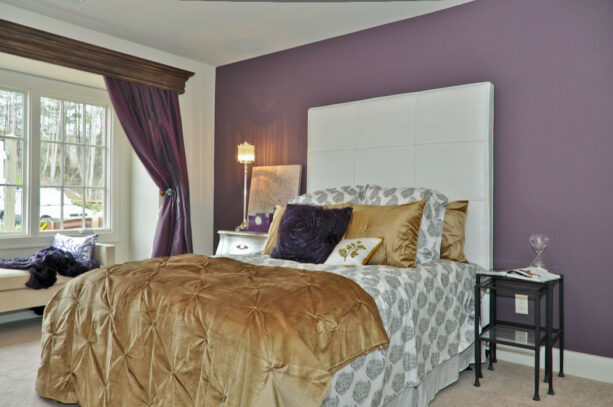 purple cabernet - benjamin moore accent wall contrasted by the white headboard