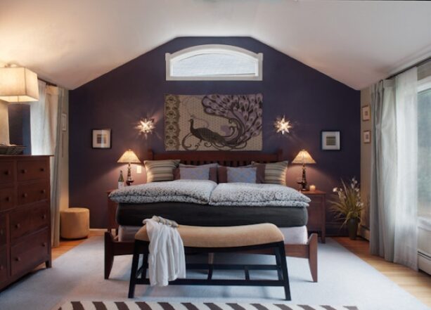 purple slanted accent wall with star sconces bracketing the artwork