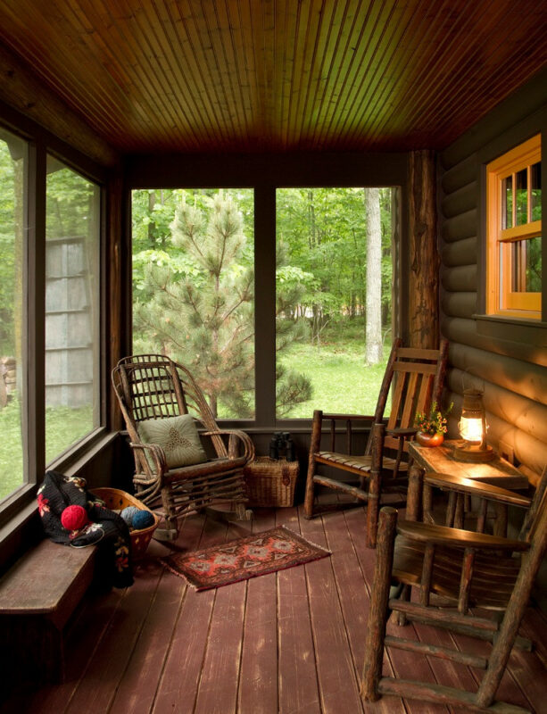 screened-in log cabin porch with a roof extension and decking