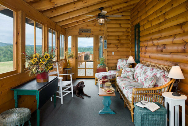shabby chic log cabin porch with comfortable seating