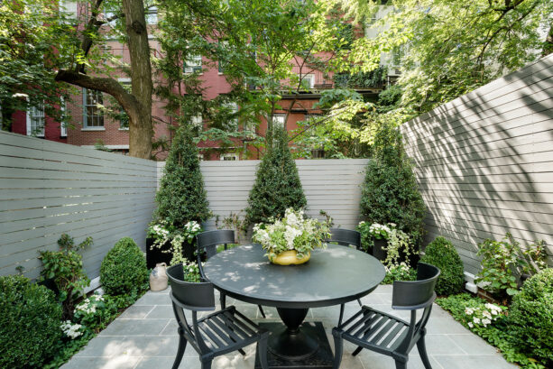 slate patio in a townhouse with surrounding fences