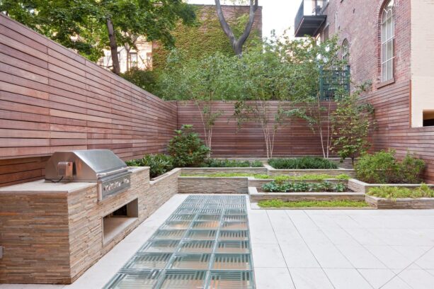 terraced landscaping in a townhouse patio with glass block decorative flooring