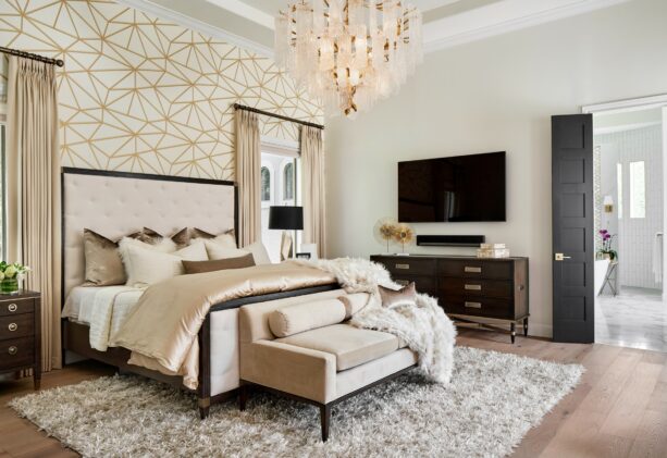 white and gold pattern headboard wallpaper accent in a transitional bedroom