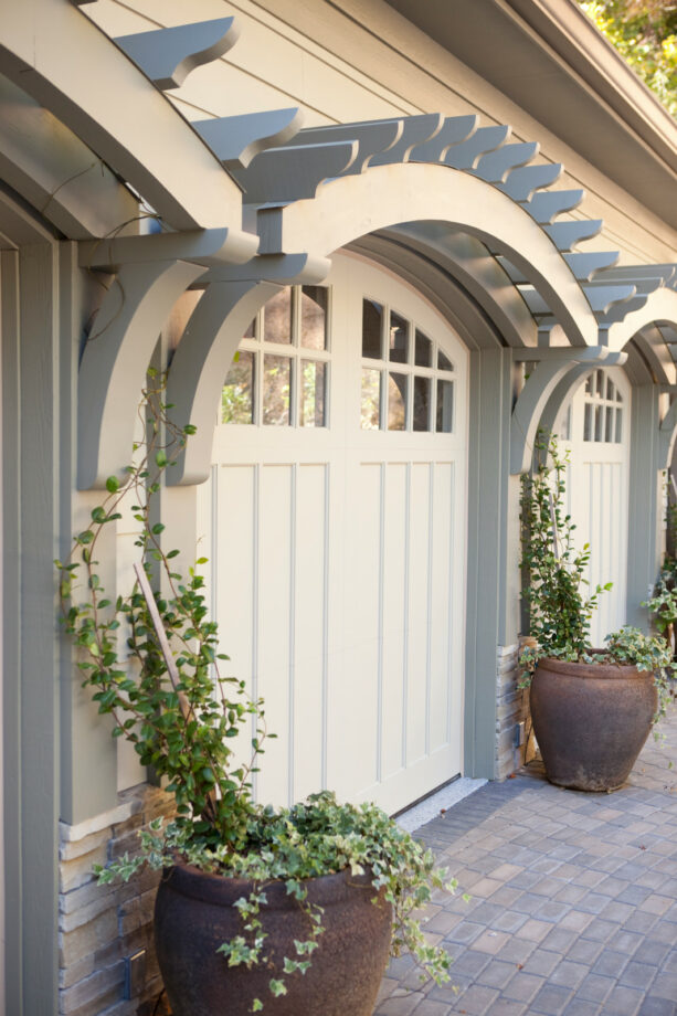 arched pergola to follow the lines of the garage doors