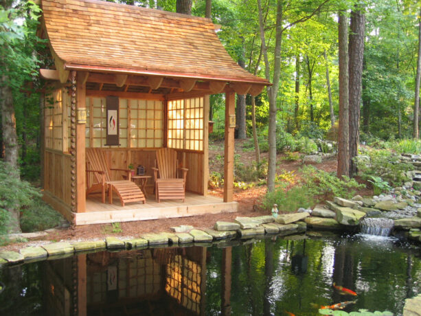 asian-style gazebo on a small deck over a koi pond