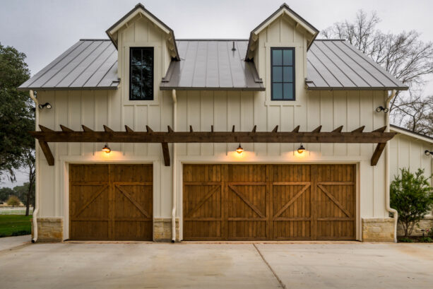 barn garage doors with a pergola over them