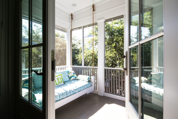 beach styled small back porch with a bed swing