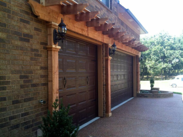 craftsman style garage with a pergola over the door