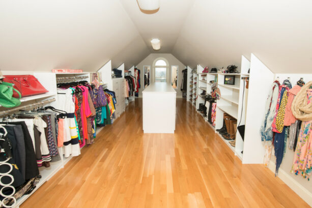 long and elegant attic closet with a cabinet in the middle