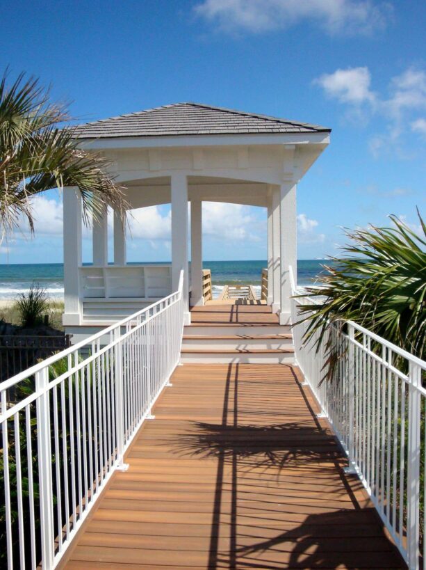 open gazebo on a coastal deck with a beach view