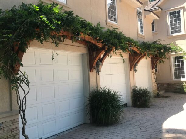 pergola with wisteria over the three-car garage door