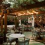 the tropical restaurant patio idea is completed with a lot of warming lights