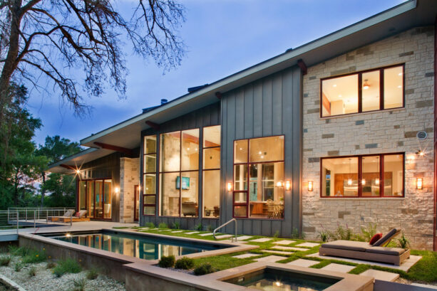 the vertical metal siding is used as an accent against the exterior stone wall