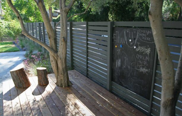 black painted mid-century modern fence with a chalkboard