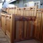 cedar craftsman-style fence with dumpster enclosure