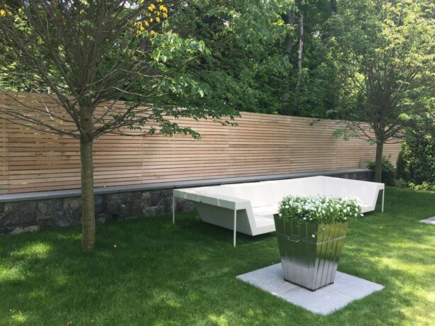 clear red cedar mid-century modern fence installed on top of concrete