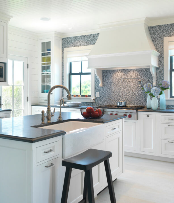 combination of glass and marble tile backsplash around the kitchen windows
