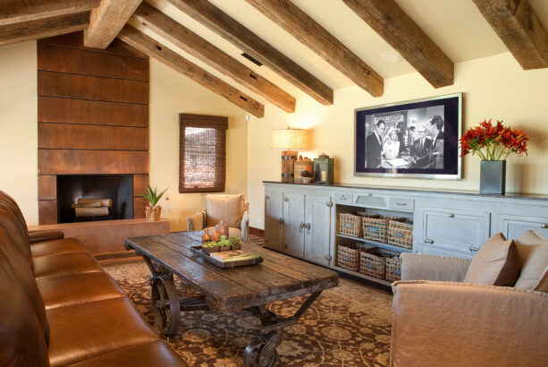 copper metal paneling surrounds the fireplace with a concrete hearth