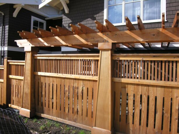craftsman-style fence with a slatted top and a pergola