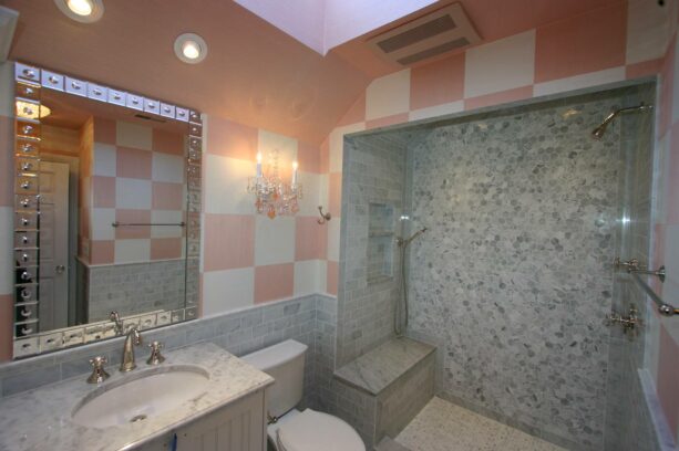 gray tiles and checkered pink bathroom walls