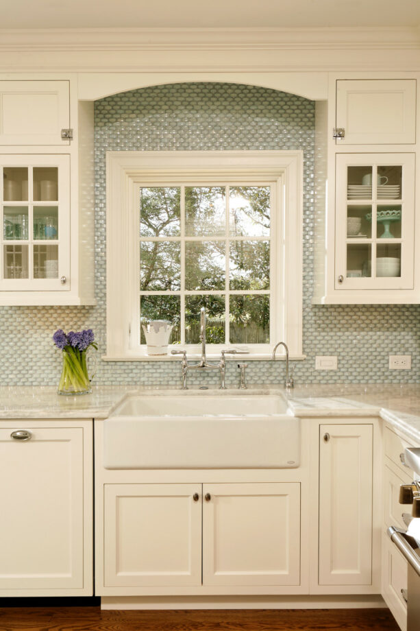 iridescent milk glass tile backsplash around a single kitchen window