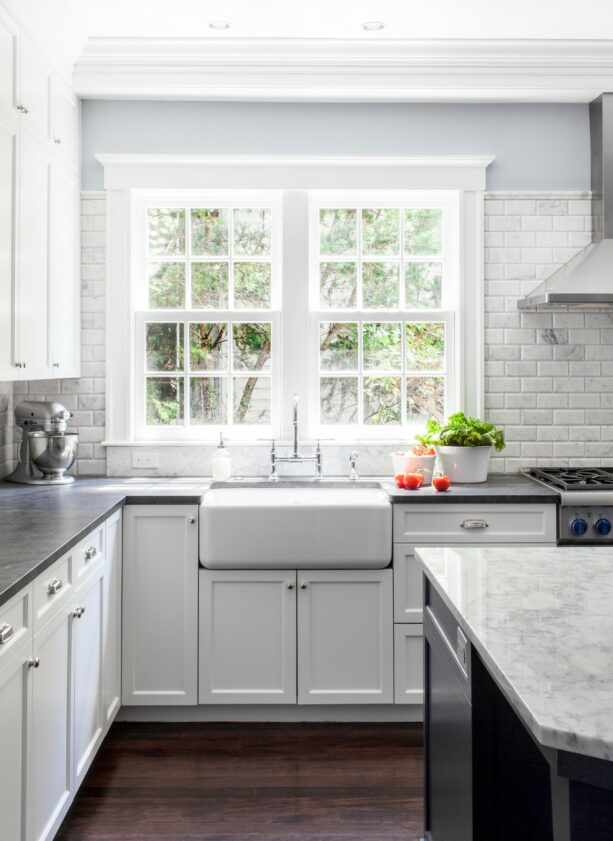 marble tile backsplash around kitchen window in a polished finish