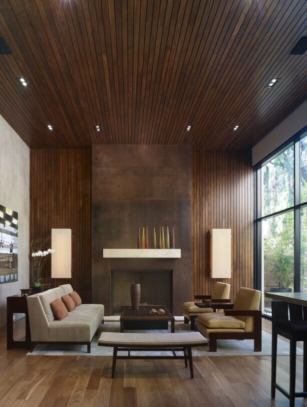 oxidized metal surround fireplace with wood wall and ceiling paneling