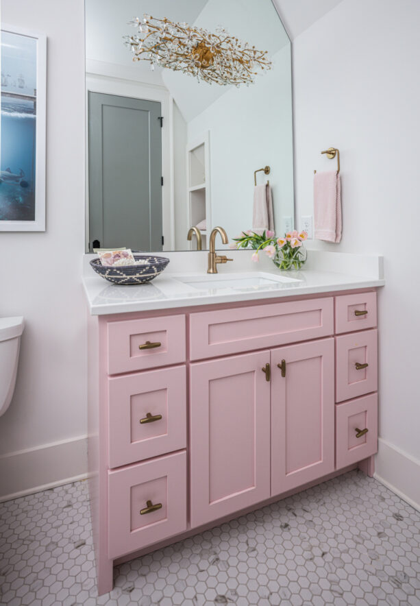 pink bathroom vanity and gray hexagonal floor tile