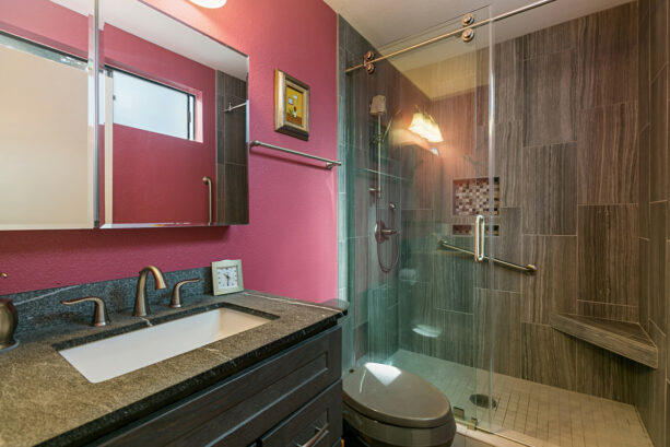 shocking pink walls combined with dark gray porcelain tile shower walls
