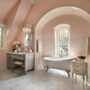 soft coral pink bathroom wall paired with gray furniture